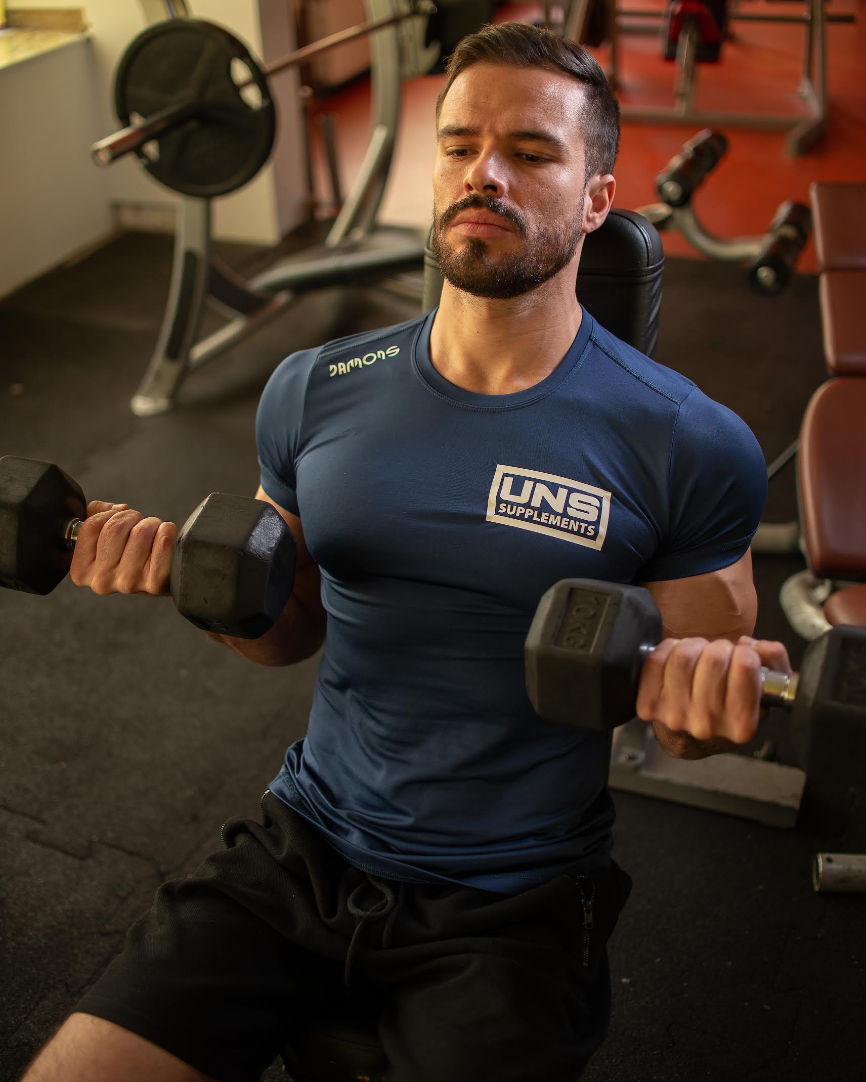 Coach performing dumbbell press during strength training session
